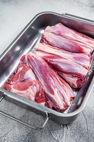lamb shanks raw in a roasting pa